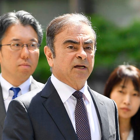 Former Nissan chairman Carlos Ghosn, center, arriv