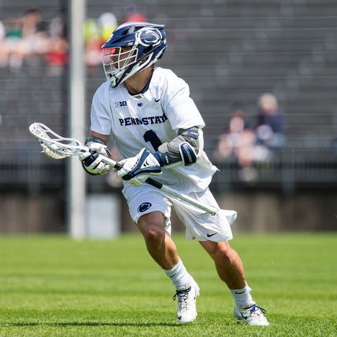 Penn State lacrosse player Grant Ament carries...