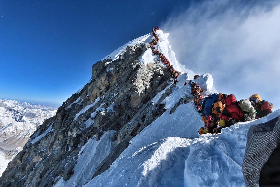 This handout photo taken on May 22, 2019, and released by climber Nirmal Purja's Project Possible expedition shows heavy traffic of mountain climbers lining up to stand at the summit of Mount Everest.