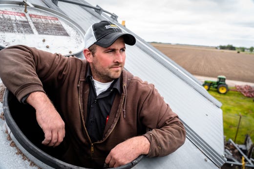 Dan Keenan, co-owner of Keenan Farms and fifth-generation farmer, poses for a photo inside a silo storing commercial soybeans that will be used for animal feed, industrial use, biofuels and lubricants that will be taken to an elevator to be dispersed in the market at his farm in Merrill on Monday, May 20, 2019.