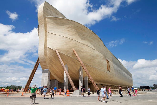 In this July 5, 2016, file photo, visitors pass outside the front of a replica Noah's Ark at the Ark Encounter theme park in Williamstown, Ky. In the Bible, the ark survived an epic flood. Yet the owners of Kentucky's Noah's ark attraction are demanding their insurance company rescue them from flooding that caused nearly $1 million in property damage.
