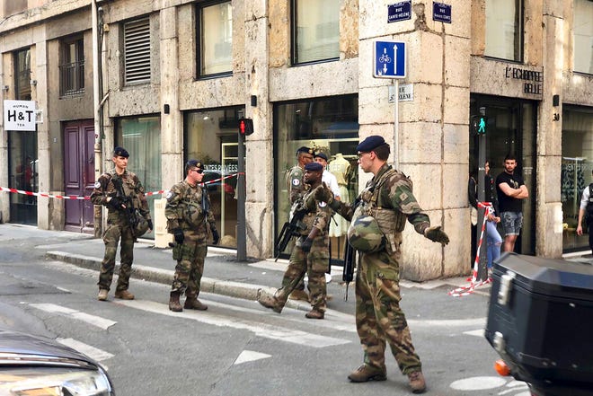 Soldiers of French anti terrorist plan "Vigipirate Mission", secure the area near the site of a suspected bomb attack in central Lyon, Friday May, 24, 2019.