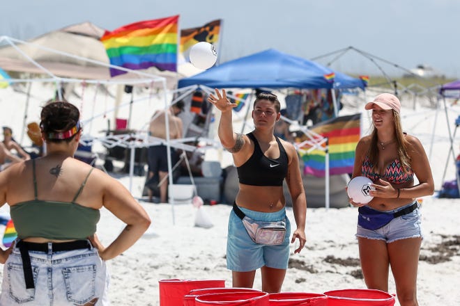 Thousands of people enjoy a beautiful day at Park East on Pensacola Beach during a past LGBT Memorial Day weekend pride event.