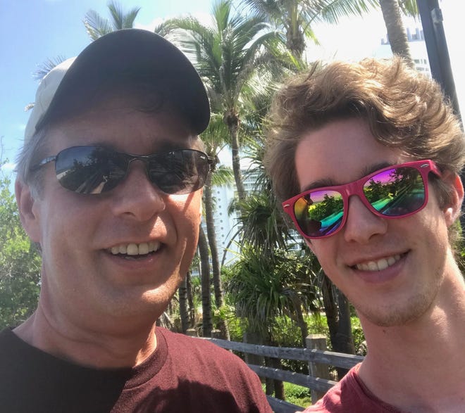 Columnist Gil Smart and his son, Alex, on the boardwalk in Miami Beach last summer.