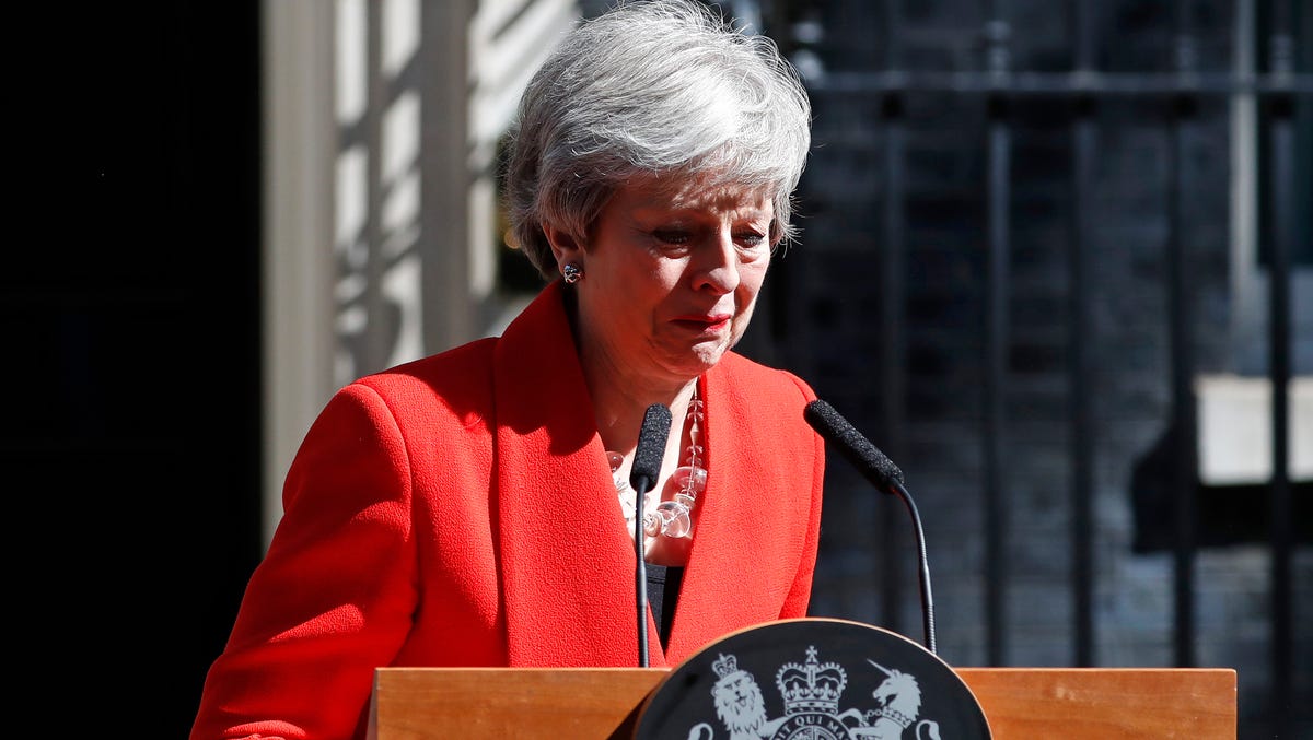 British Prime Minister Theresa May reacts as she turns away after making a speech in the street outside 10 Downing Street in London, England, Friday, May 24, 2019. Theresa May says she'll quit as UK Conservative leader on June 7, sparking contest for Britain's next prime minister.