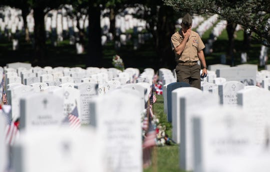 A US Army member visits Section 60 at Arlington National Cemetery on May 24, 2019, before the Memorial Day weekend.