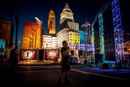 Drew Lachey stretches behind the stage of "American Ninja Warrior," as he prepares to compete in downtown Cincinnati Friday, May 24, 2019. 