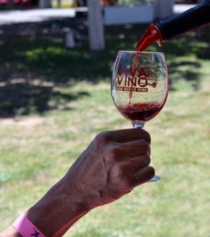 A guest of the 2019 Las Cruces Wine Festival gets a refill on Saturday, May 25, 2019.