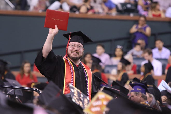 College of the Desert graduate John Hitchcock reacts after receiving his diploma during the commencement ceremony at the Indian Wells Tennis Garden in Indian Wells on Friday, May 24, 2019.