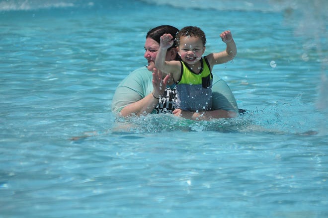 Sarah Sweeney holds 2-year-old Dominic as he enjoys Cordell Municipal Pool on Saturday, May 25, 2019.