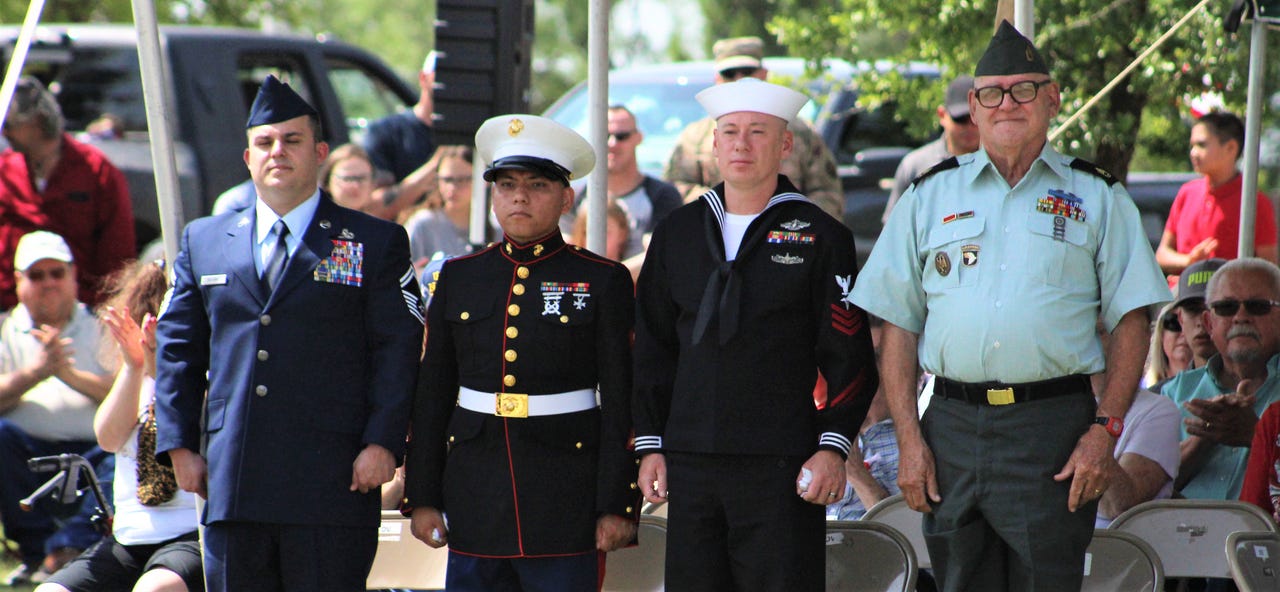 The Air Force (from left), Marine Corps, Navy and Army were represented by the uniforms of four attendees at Monday's Memorial Day ceremony at Texas State Veterans Cemetery at Abilene. The four were asked to stand, to applause from large crowd.