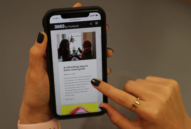 A woman looks at a Ramadan-related page on her mobile phone in Dubai, United Arab Emirates.