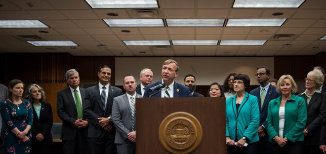 Flanked by the Board of Trustees and members of the presidential search committee, newly announced Michigan State University President Samuel Stanley Jr. addresses the press Tuesday, May 28, 2019.