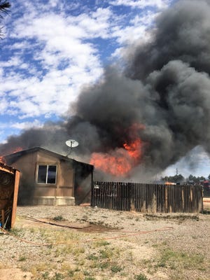 A grass fire burned down the Webber home in Alamogordo May 6.