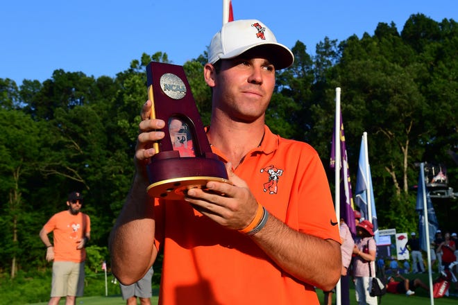 Oklahoma State sophomore Matt Wolff, a Westlake High graduate, holds up the trophy after winning the NCAA individual men's golf title Monday.