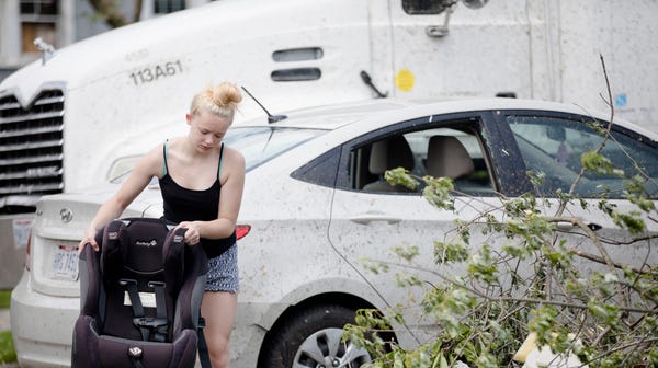 Sally Roberts cleans off her nieces car seat...
