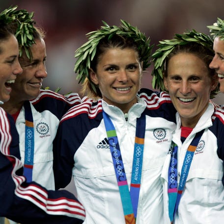 Aug. 26, 2004: Julie Foudy, Joy Fawcett, Mia Hamm, Kristine Lilly and Brandi Chastain receiving their Olympic gold medal beating Brazil 2 -1 in overtime at Karaiskaki Stadium.