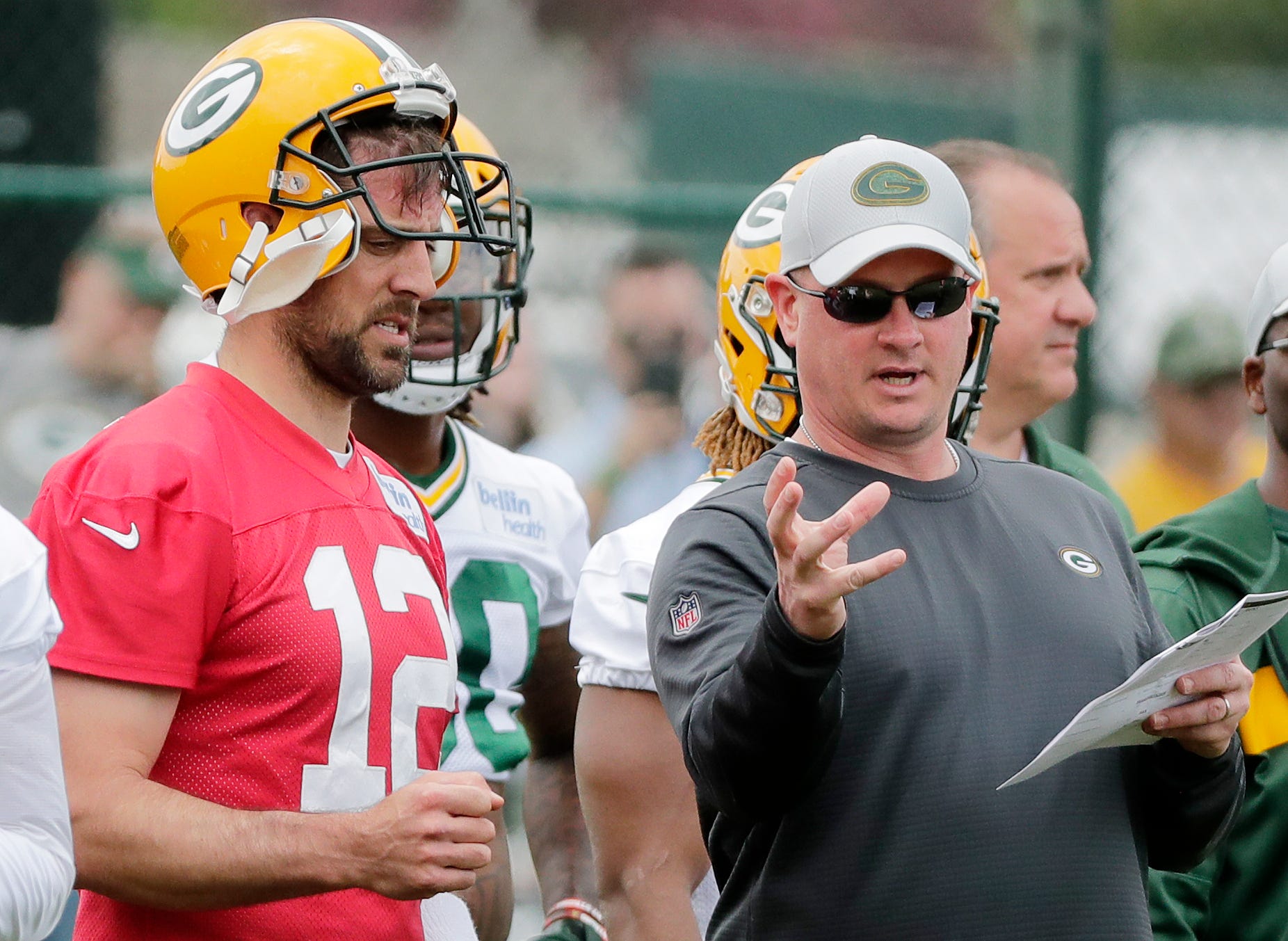 Aaron Rodgers, Nathaniel Hackett talking during practice.