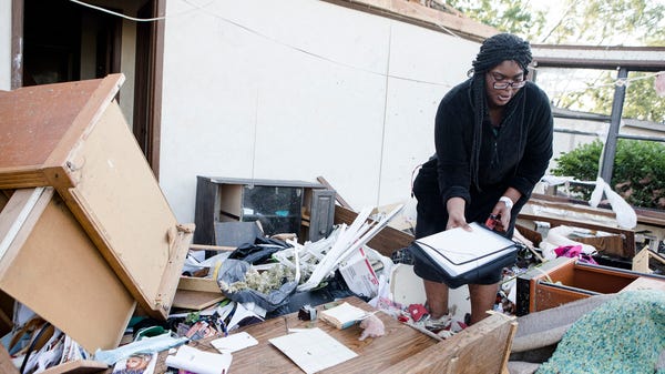 Latisha Anderson digs through her personal items...