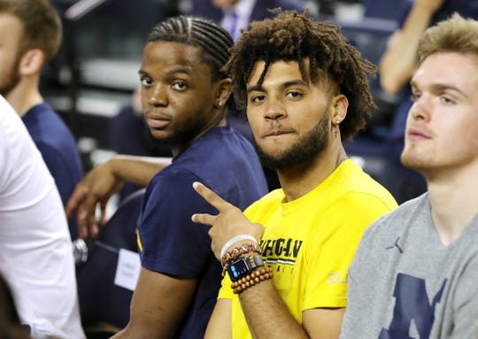 Michigan basketball players Zavier Simpson, left, and Isaiah Livers in the hearing as new head coach Juwan Howard, answer questions on Thursday, May 30, 2019 at the Crisler Center in Ann Arbor, Michigan.