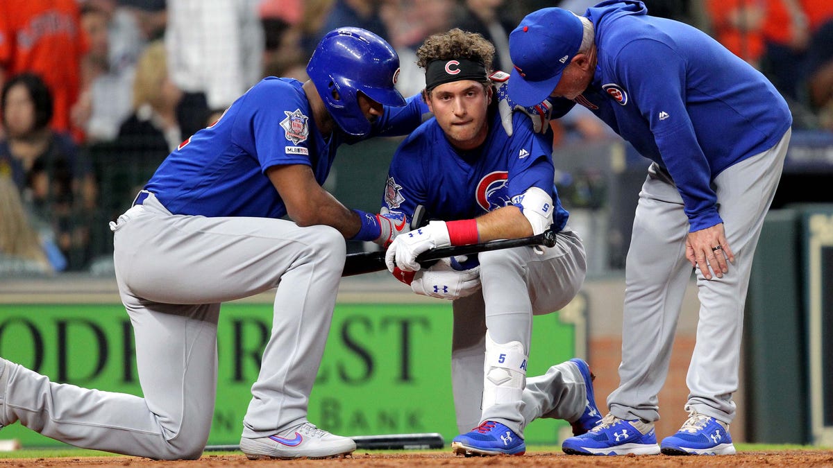Cubs outfielder Albert Almora, center, is consoled by teammate Jason Heyward and manager Joe Maddon after a young fan at Minute Maid Park was hit by a foul ball during the fourth inning Wednesday against the Astros.