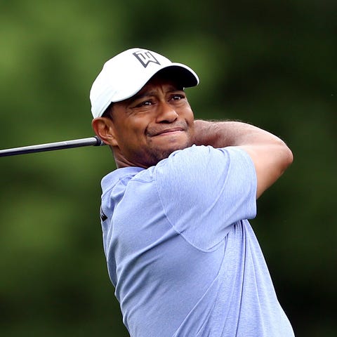Tiger Woods tees off on the 18th hole during the...