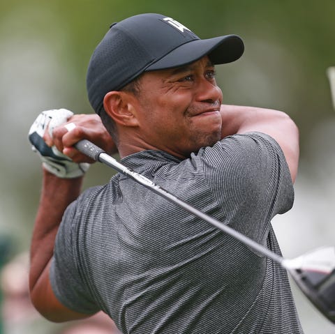 Tiger Woods hits his tee shot on 15th hole during...