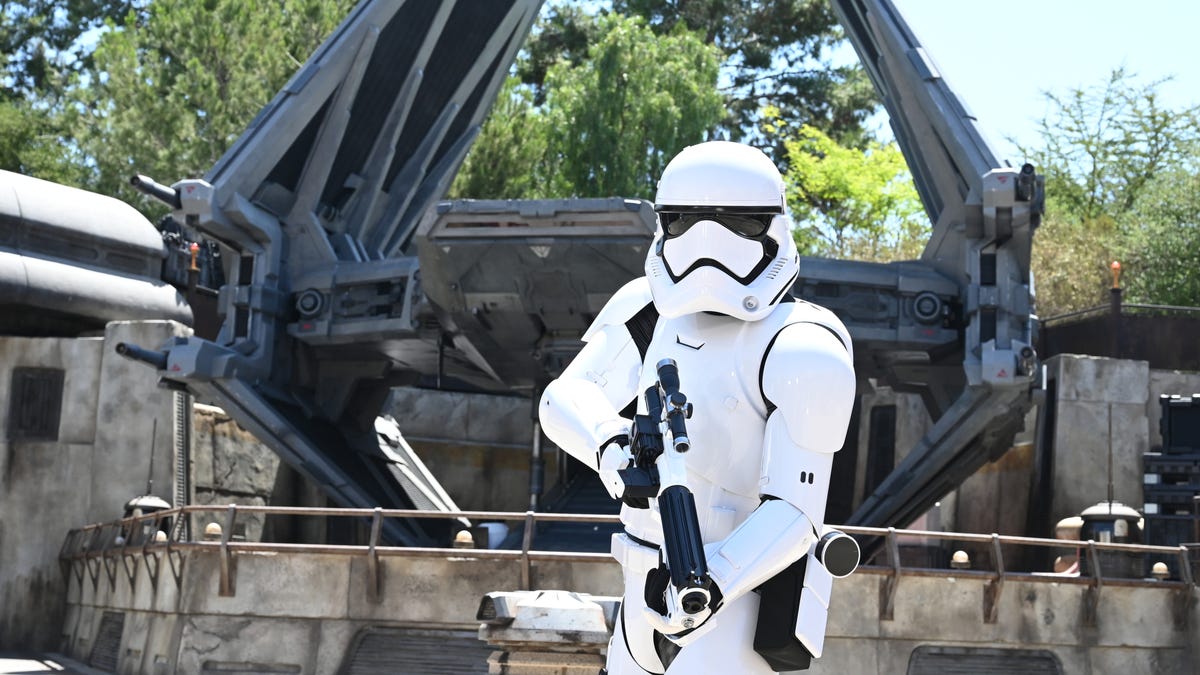 An Imperial Storm Trooper stands guard over a Tie Fighter at Star Wars: Galaxy's Edge.