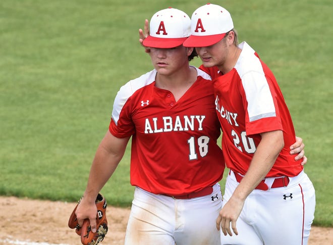 Albany’s Ryan Hill, right, congratulates Josh Dyer after winning 7-6 in Game 2 of the Region I-2A final series against New Deal at Moffett Field in Snyder on Friday. Dyer got the final five outs in the victory and Hill collected a base hit in his only at bat.