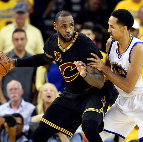 LeBron James and Shaun Livingston mix it up in...