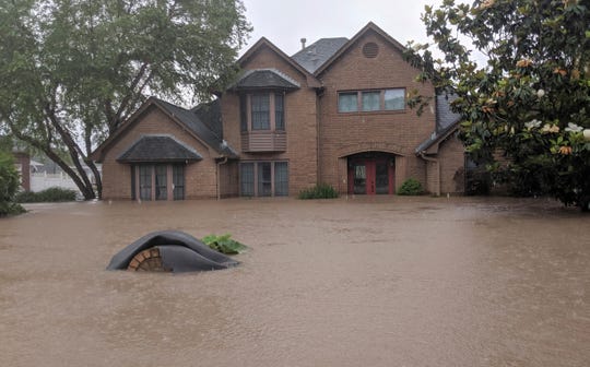 Flood waters surround homes in Fort Smith, Arkansas, May 29, 2019.