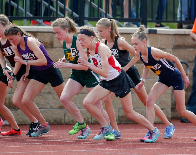 Pinckney's Noelle Adriaens, center, begins the 3200 meter run, Saturday, June 1, 2019, at East Kentwood High School in Kentwood, Mich.