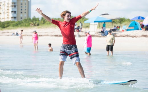 "This is a community, not just an event. We come together to give these families a day at the beach and no one judges them. They get to see their kids do something amazing," said Tracy Bastante, not pictured, of Coconut Creek, who watched her son, Damian Richter, 17, center, surf during the Surfers for Autism's Fort Pierce Surf & Beach Festival on Saturday, June 1, 2019, at Pepper Park Beach in Fort Pierce. "My son started when he was five and now he surfs competitively. It gave him self-confidence and an identity," said Bastante, who helped organize the event. Adults with autism or parents and guardians of children with autism were asked to submit a surfer participation request. Surfing was limited to 200 participants for safety and to ensure enough time with the instructors. The event was free.