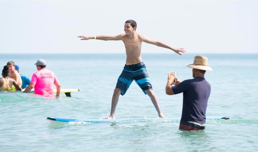 &quot;I&#39;m semi-new to Florida and didn&#39;t know there were group events like these for children with autism. It&#39;s amazing. He&#39;s loving it,&quot; said Nicole Columbo, not pictured, of Palm Bay, who watched her son, Matthew, 13, center, learn to surf during the Surfers for Autism&#39;s Fort Pierce Surf &amp; Beach Festival on Saturday, June 1, 2019, at Pepper Park Beach in Fort Pierce. Adults with autism or parents and guardians of children with autism were asked to submit a surfer participation request. Surfing was limited to 200 participants for safety and to ensure enough time with the instructors. The event was free.