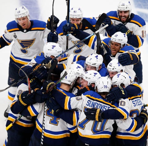 Blues players celebrate after the Game 2 win in...