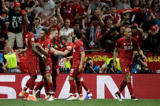 Liverpool's Divock Origi, left, celebrates with teammates after scoring in the 87th minute in the Champions League final.