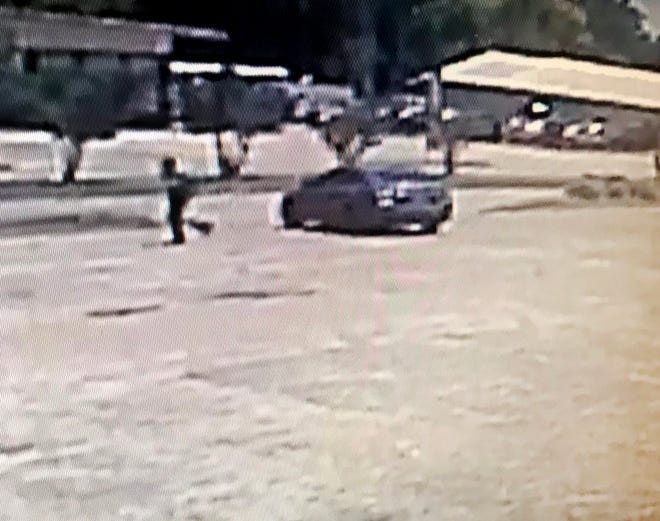 This is a surveillance image of a vehicle a suspect exited just before a fatal shooting on Medgar Evers Blvd. on Saturday, June 1, 2019. The vehicle is a dark-colored four-door sedan, possibly a Nissan.