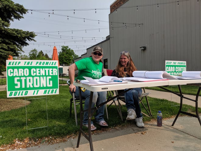 Katie Ozorowicz, 28, and Reamy Berlin, 41, collect signatures for a Caro Center petition on May 31, 2019.