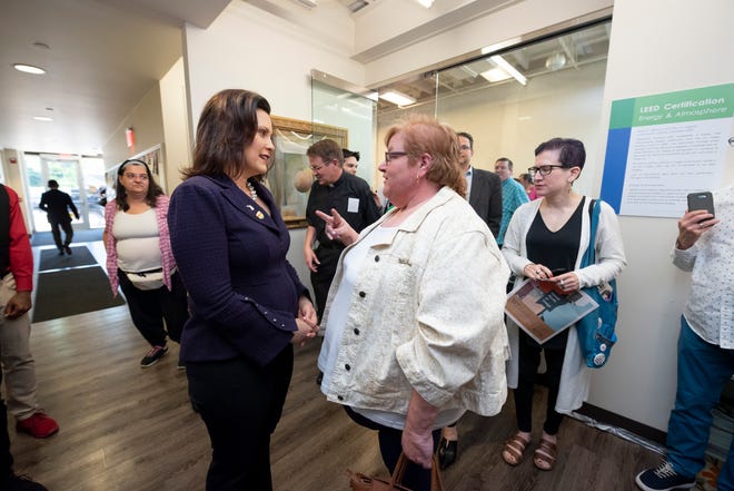 Michigan Gov. Gretchen Whitmer, left, chats with Genny Maze of Royal Oak after a pride town hall meeting at Affirmations, in Ferndale, Monday evening.