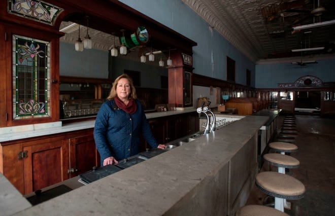 In this May 20, 2019 photo, Heather Hanover stands inside the future home of Hanover's Michigan Mints in downtown St. Johns, Mich.