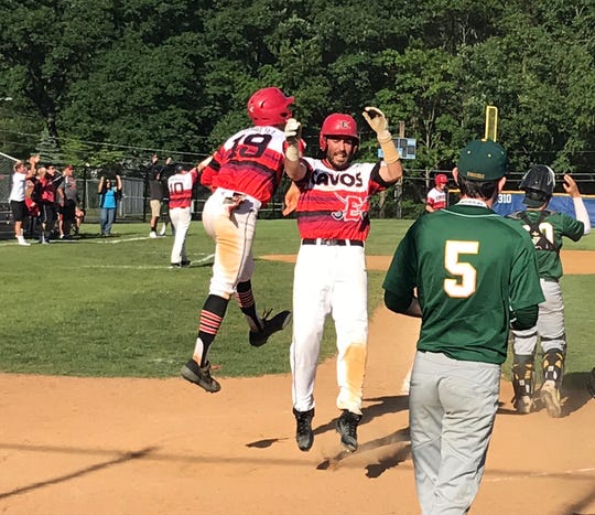 Seniors Peter Durocher (19) and Joe Carmosino celebrate after scoring the tying and go-ahead runs in the fifth inning of Emerson's Group 1 state-semifinal win over New Providence. Durocher later drove in the winning run to lift the Cavos to an eight-inning, 9-8 win on Monday, June 3, 2019.