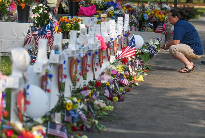People stop by the memorial at the Municipal Center to pay their respects to the victims of the May 31 mass shooting that killed 12 in Virginia Beach, Virginia.