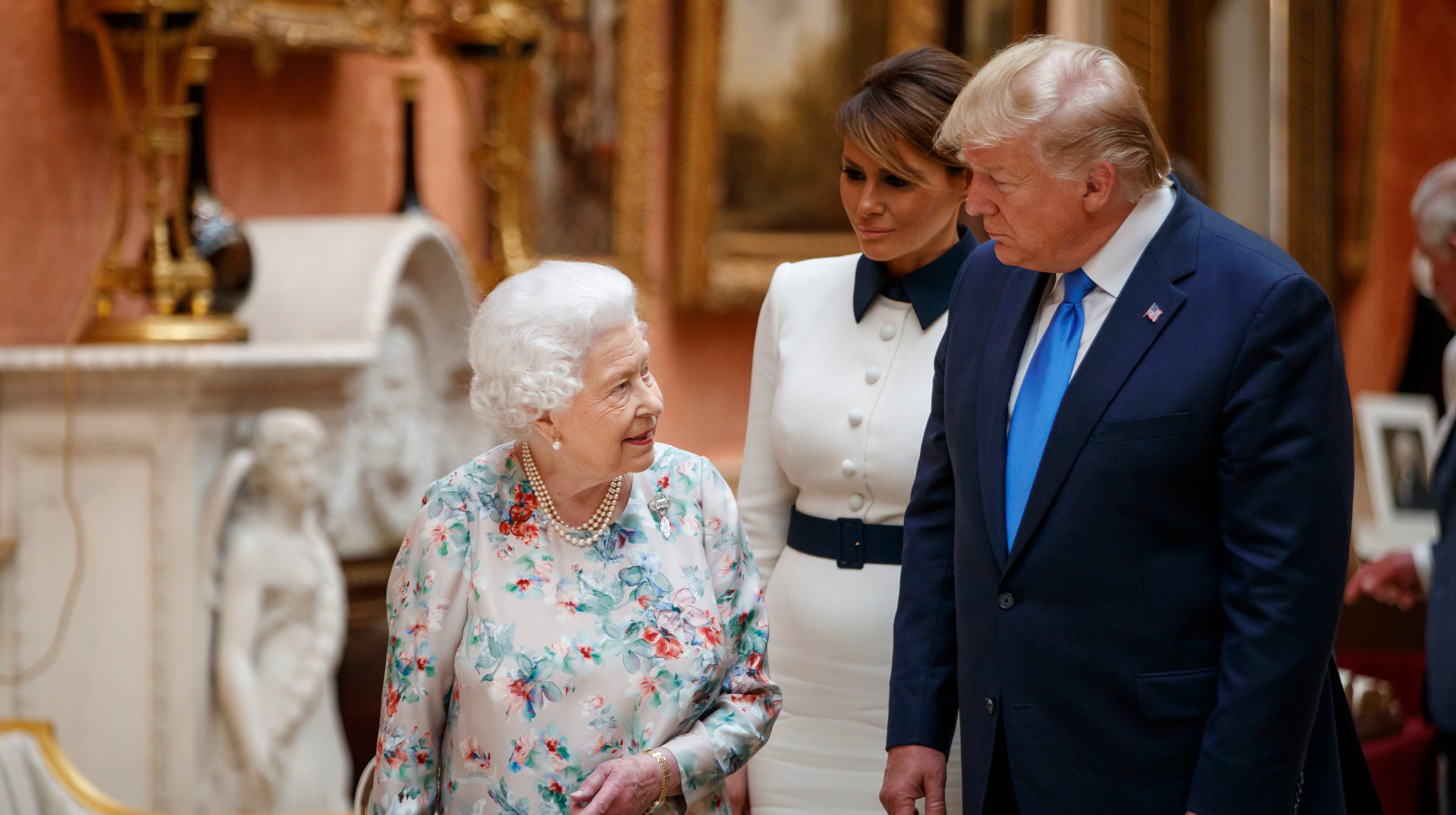 Queen Elizabeth II, President Trump and and First Lady Melania Trump view displays of U.S. items in the Royal collection at Buckingham Palace on June 3, 2019 in London.