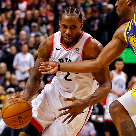 Raptors forward Kawhi Leonard drives to the...