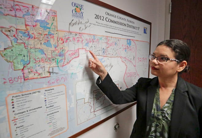 Orange County Commissioner Emily Bonilla looks at a map of Orange County and the city of Orlando in Orlando, Fla. Bonilla is worried her district in metro Orlando will be undercounted during next spring's once-in-a-decade head count of everybody in the United States because of who lives there: new arrivals, immigrants, the poor, renters and people living in rural areas who sometimes regard government with suspicion.