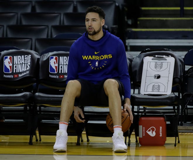 Golden State's Klay Thompson sits on the bench during Tuesday's practice.