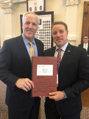 State Sen. James Frank, R-Wichita Falls, and state Sen. Pat Fallon, R-Prosper, holding a folder for Lauren's Law, Senate Bill 719 authored by Fallon, just after he voted to concur with House amendments on his bill.