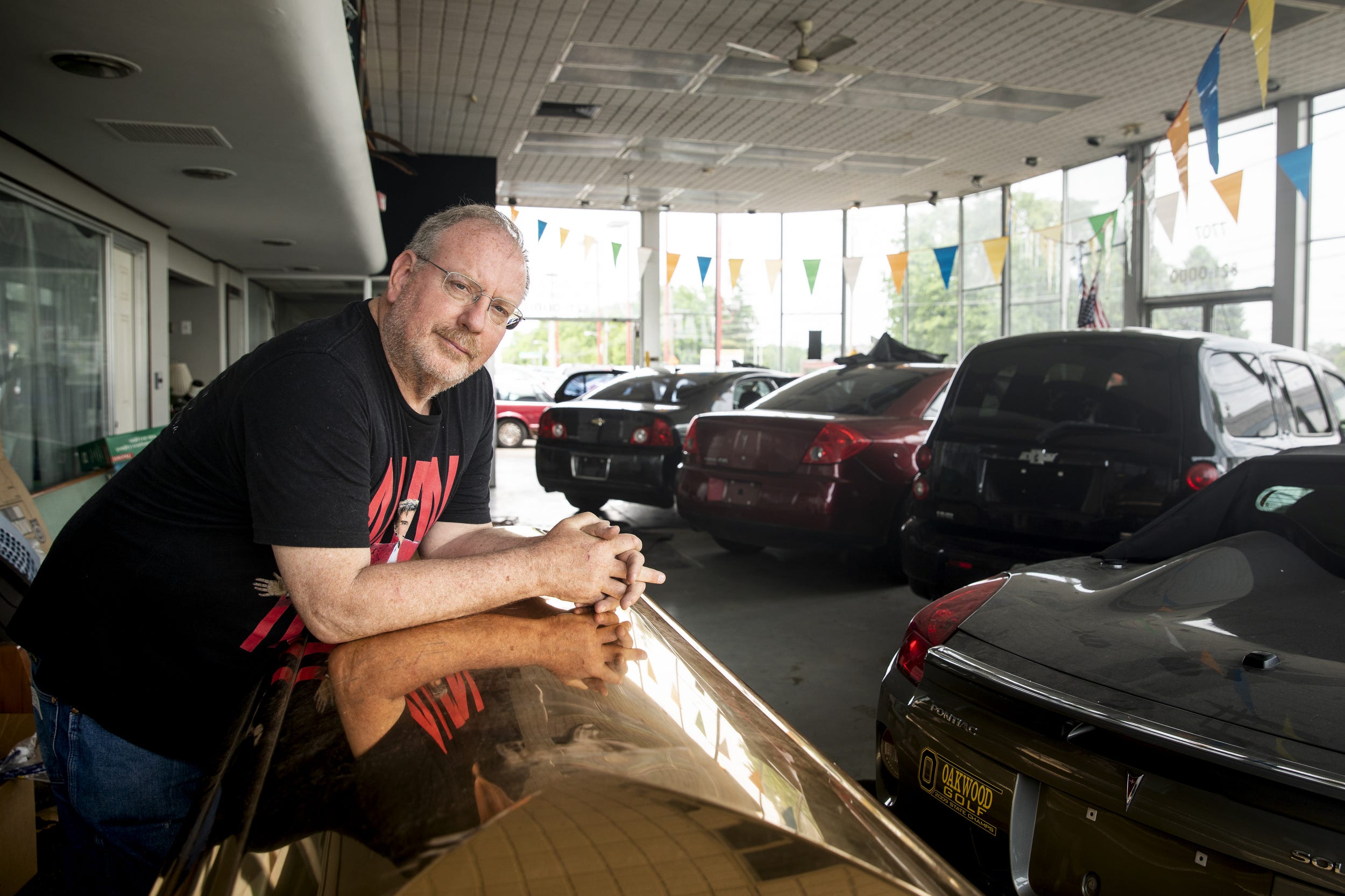 Carl Woerner, the owner of CW Coach Sales, sells hearses, limousines and other used cars on his 10-acre lot.