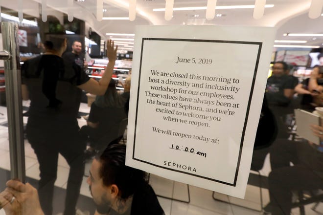 Sephora employees gather in one of the company's closed stores, in New York, Wednesday, June 5, 2019. Sephora is closing its U.S. stores for an hour Wednesday to host inclusion workshops for its employees, just over a month after R&B star SZA said she had security called on her while shopping at a store in California. (AP Photo/Richard Drew)