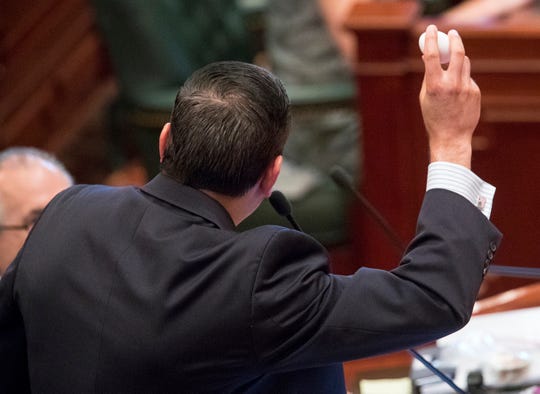 Illinois state Rep. Anthony DeLuca, D-Chicago Heights, holds up an egg before cracking it into a pan to reference the "This is your brain on drugs," campaign during debate on a bill to legalize recreational marijuana use in the Illinois House chambers Friday, May 31, 2019. DeLuca voted against the bill that passed the House 66-47.